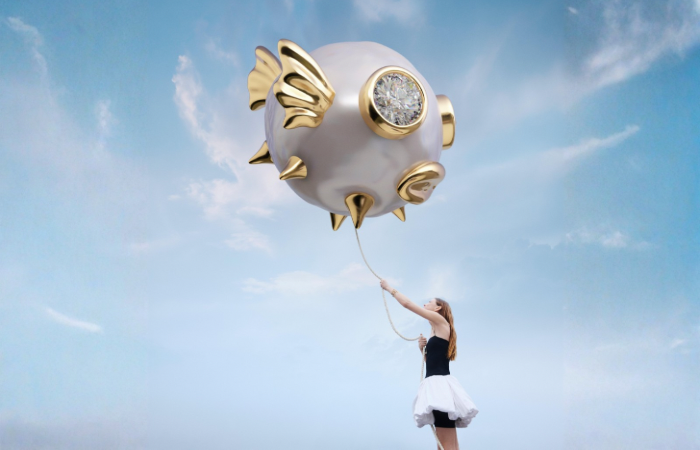 Pandora Wonders x Harry Lambert campaign — oversized pufferfish pearl charm held aloft against a blue sky
