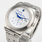 Silver watch with a humorous message on the dial against a blurred background