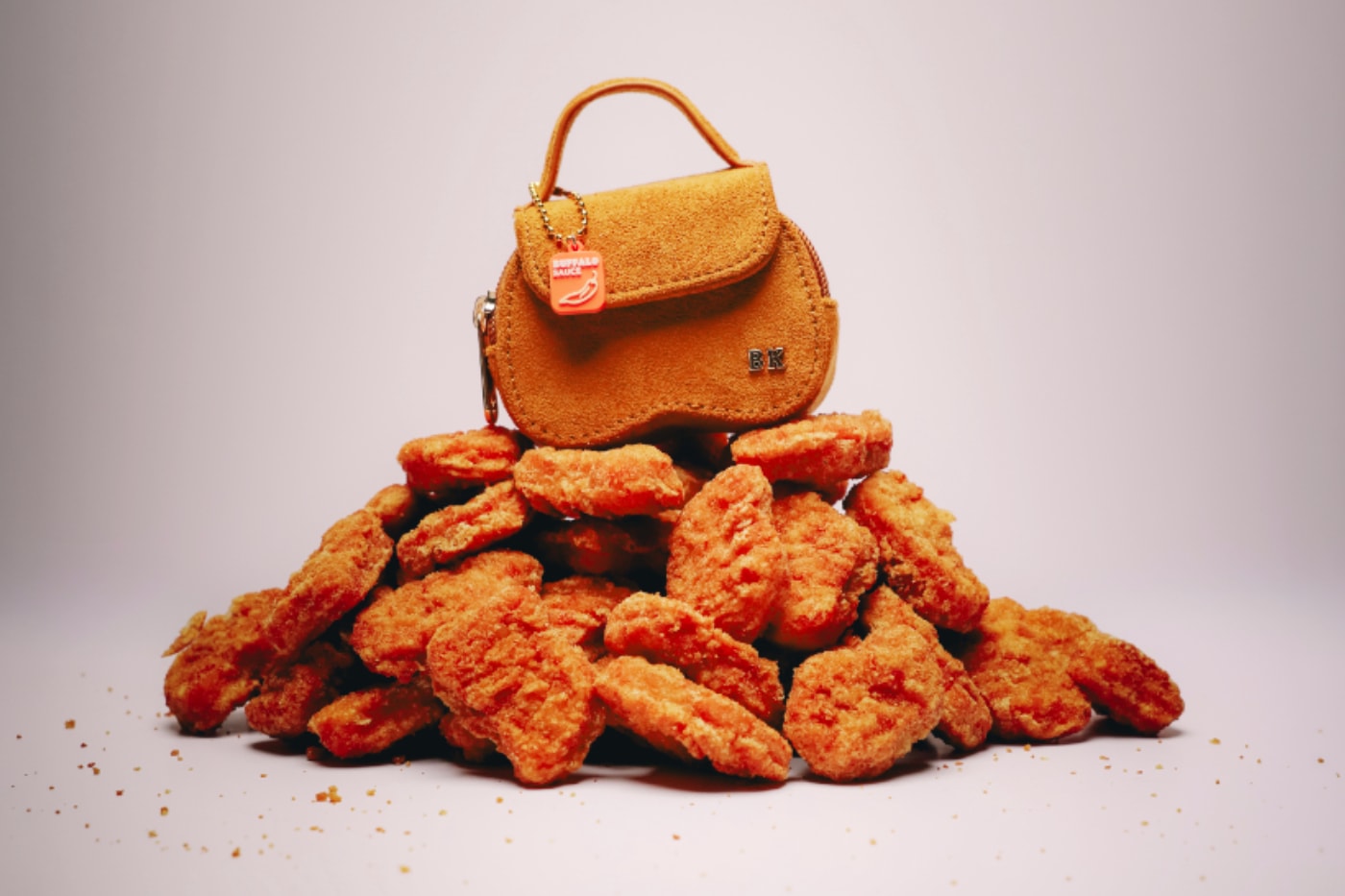 Tiny Burger King nugget-shaped handbag on a pile of chicken nuggets