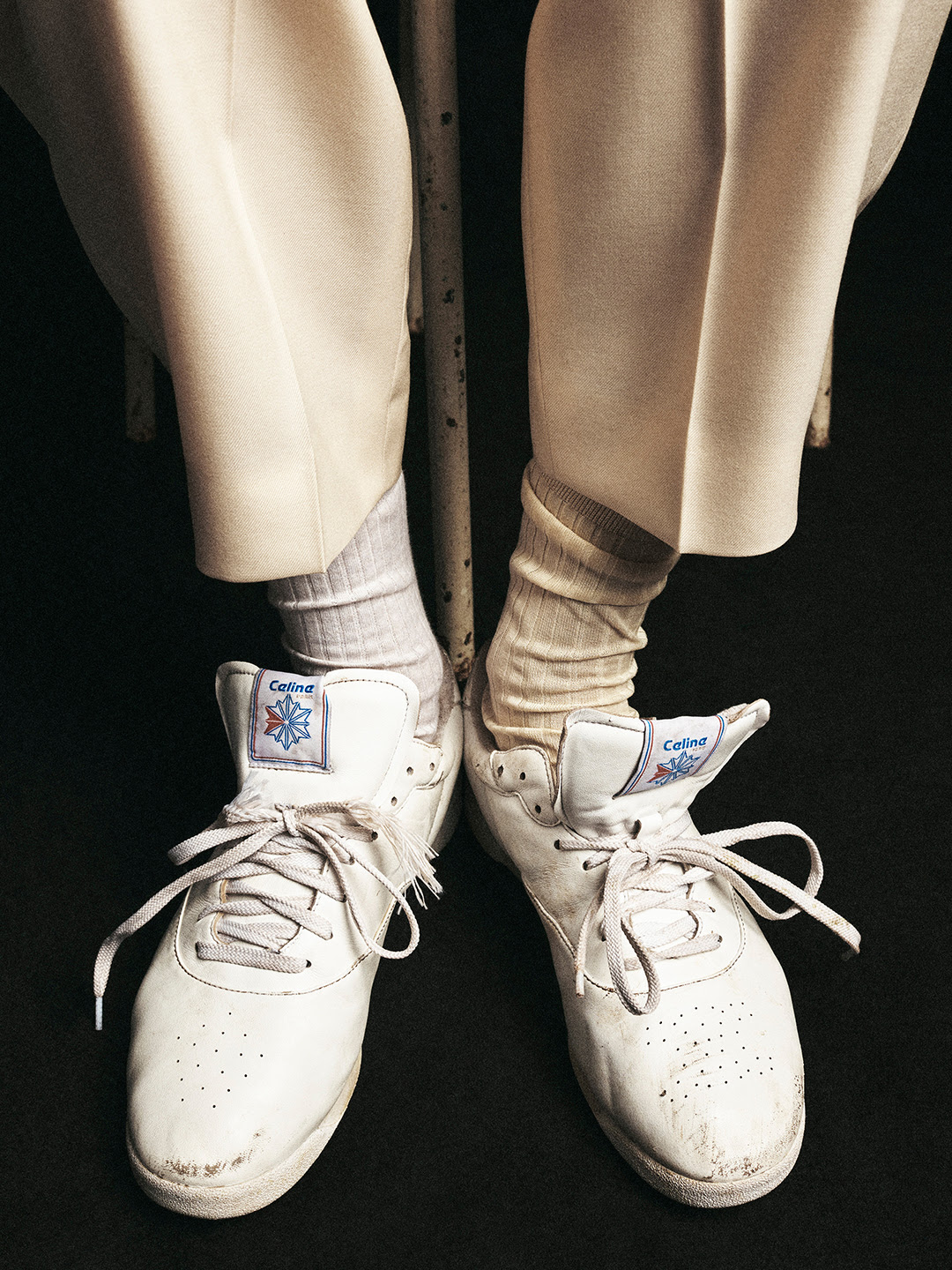 A worn-in pair of white Celine by Reebok Freestyle Lo trainers