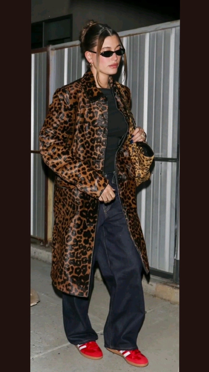 Street-style reference: a glossy leopard coat worn with wide-leg denim and red trainers