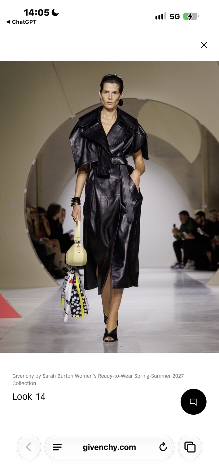 Belted black leather trench dress with a pale-yellow bag and printed scarf
