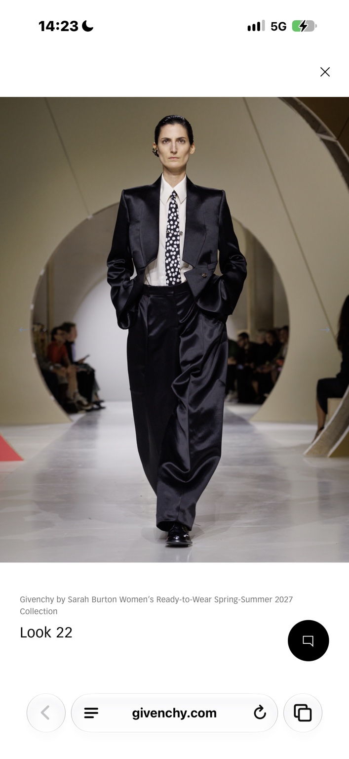 Black satin tuxedo with spotted tie and fluid trousers