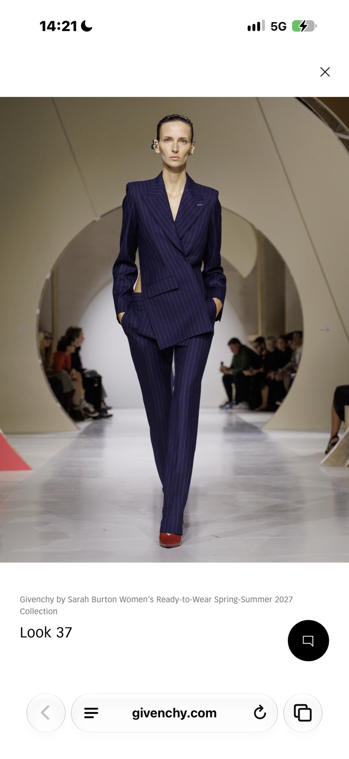 Asymmetric navy pinstripe trouser suit with a cutaway waist