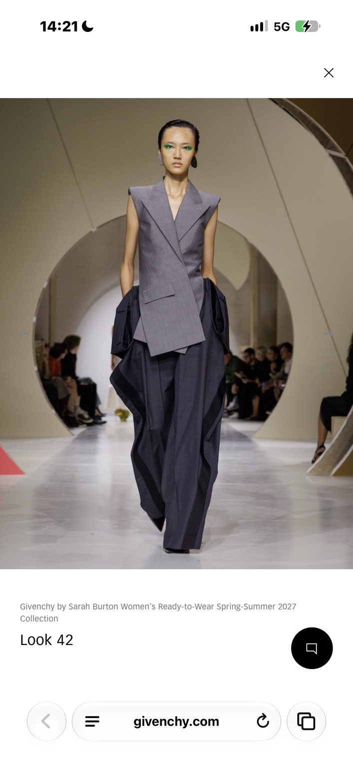 Grey sleeveless asymmetric jacket with voluminous draped trousers