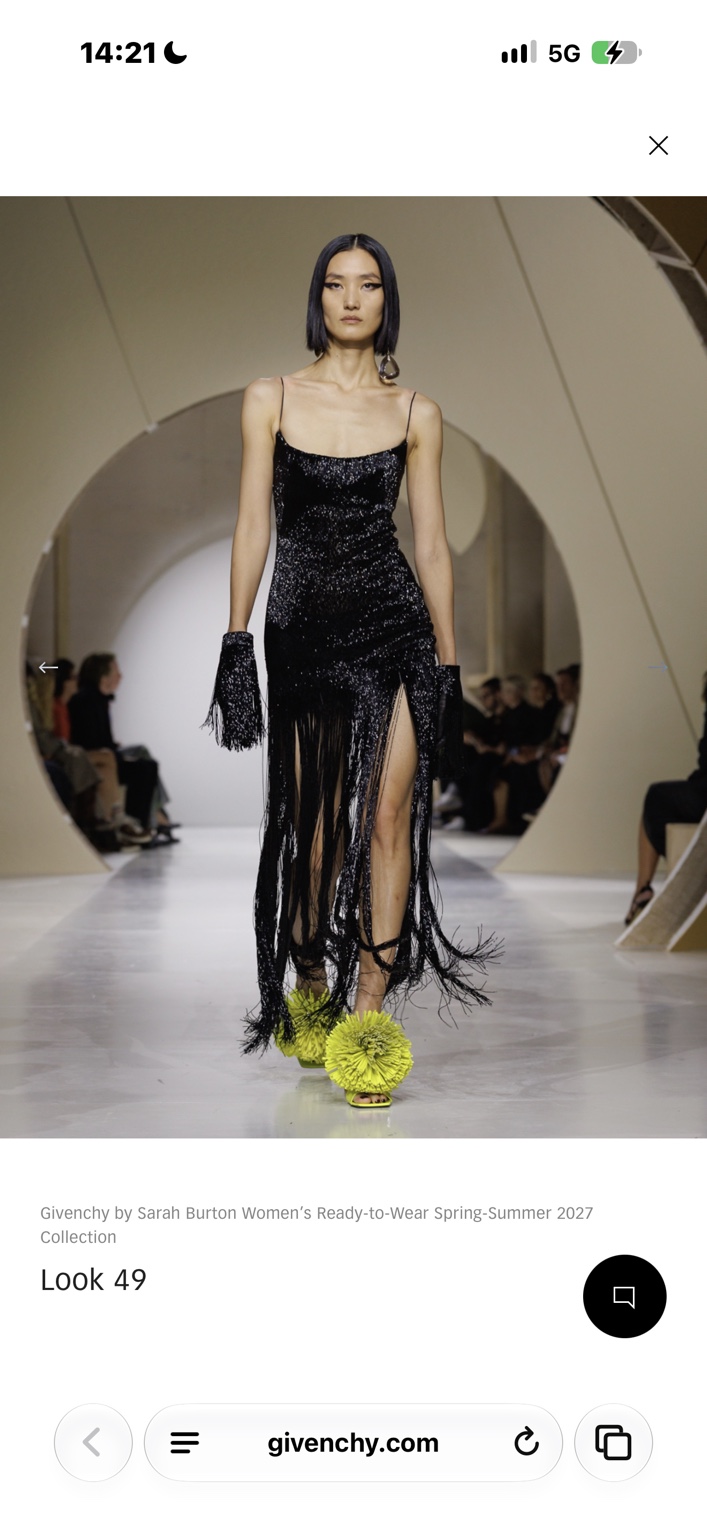 Black fringed evening gown with chartreuse pom-pom shoes