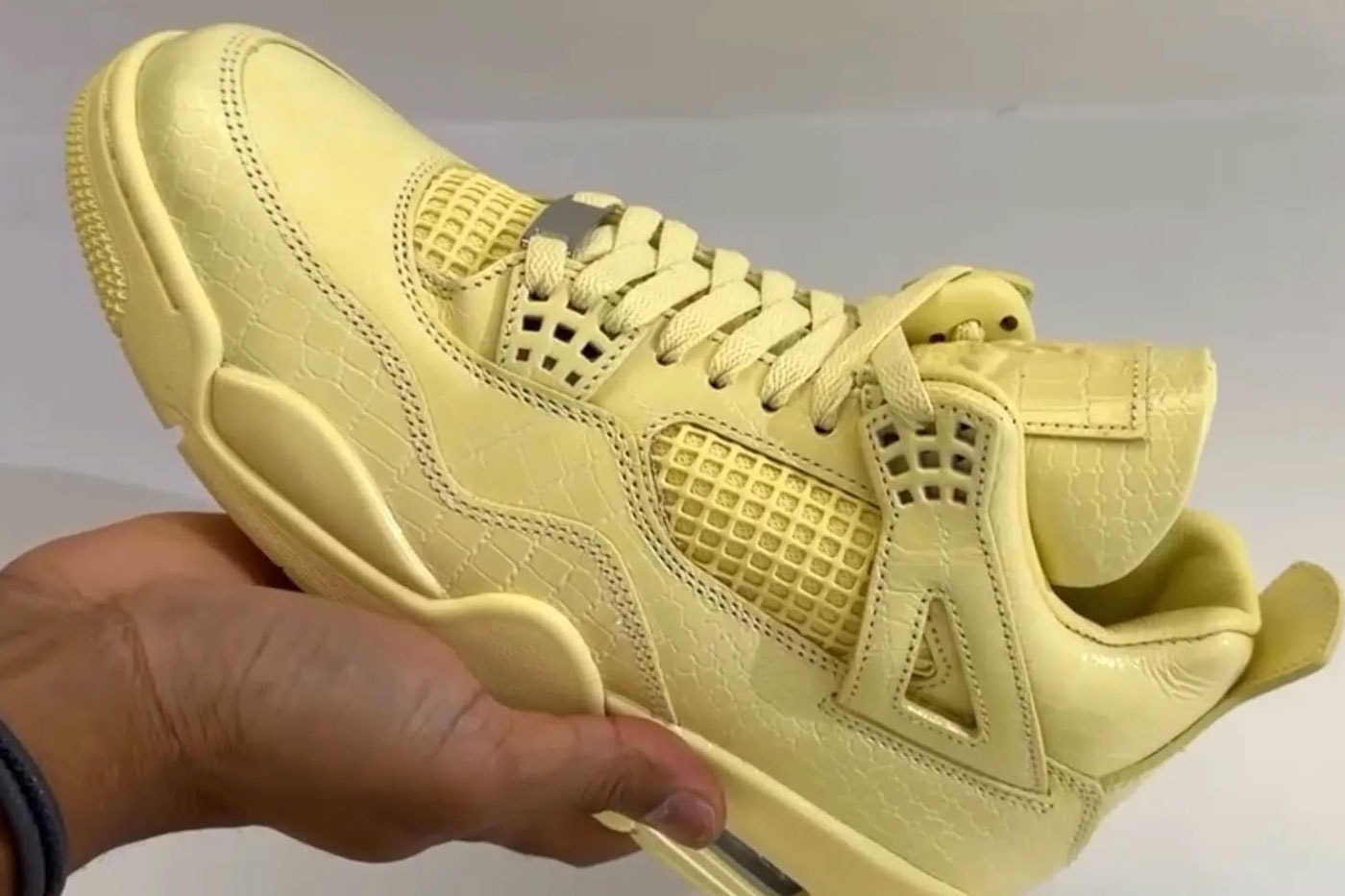 Close view of the yellow J Balvin Air Jordan 4 Lemonade