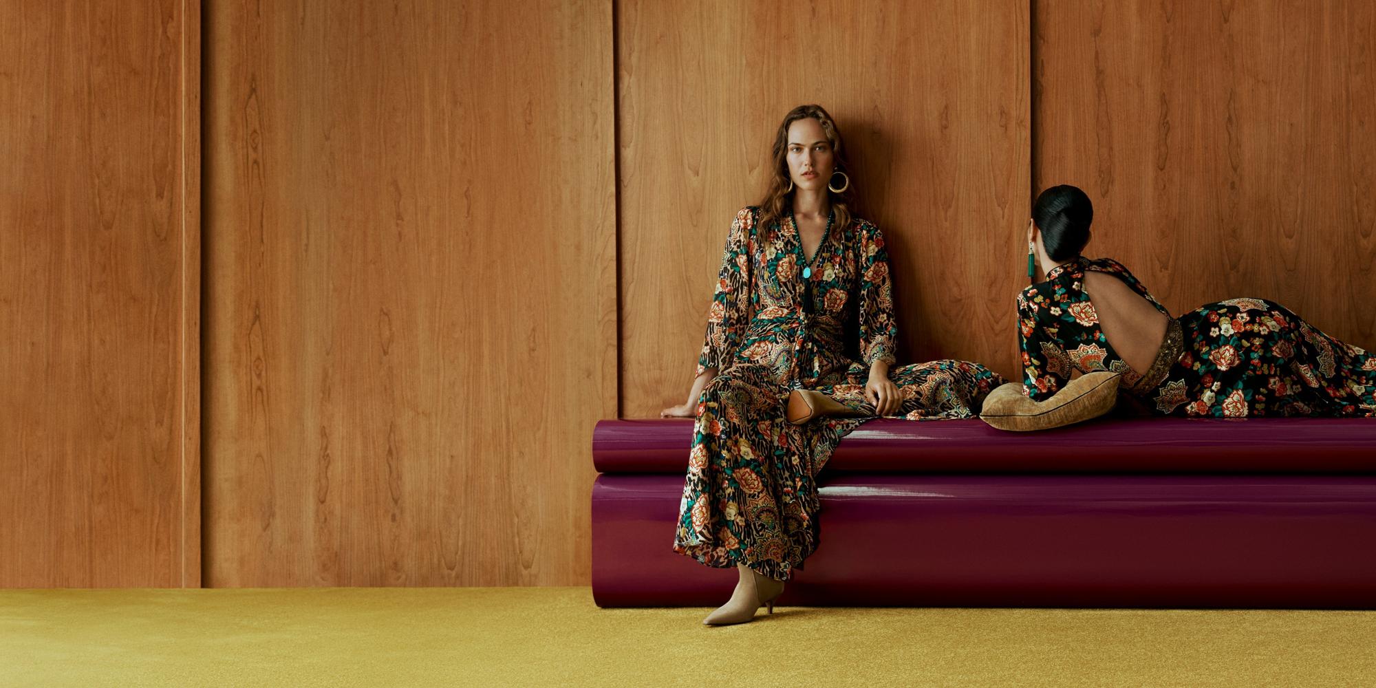Two models wearing John Lewis x RIXO dresses in the 1849 archive floral print