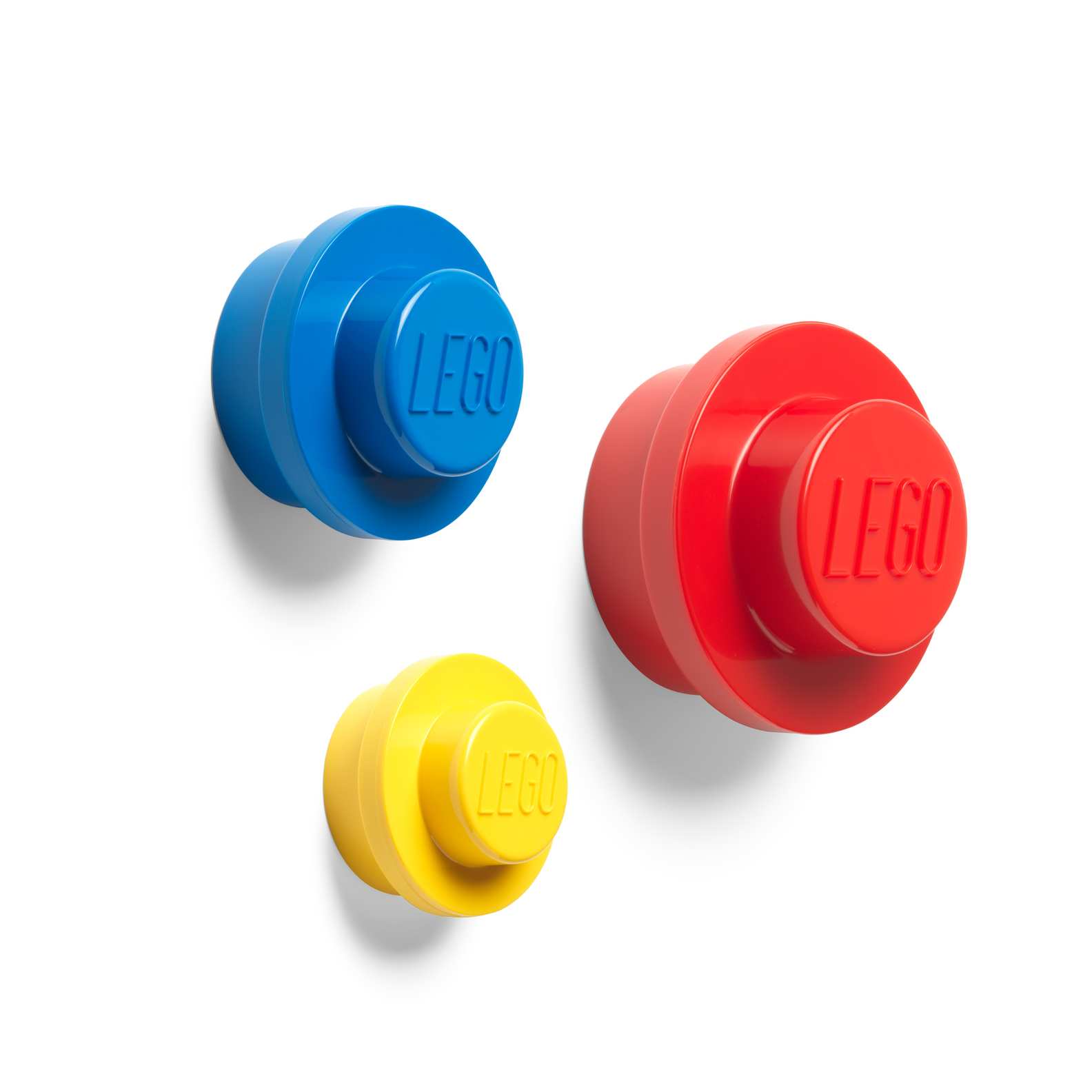 Three LEGO wall hooks in blue, red and yellow