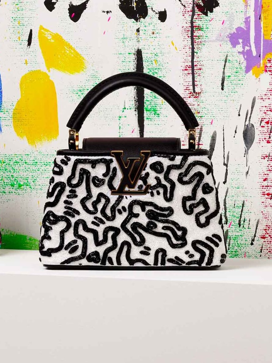 Black and white Louis Vuitton Capucines bag covered in beaded Keith Haring figures
