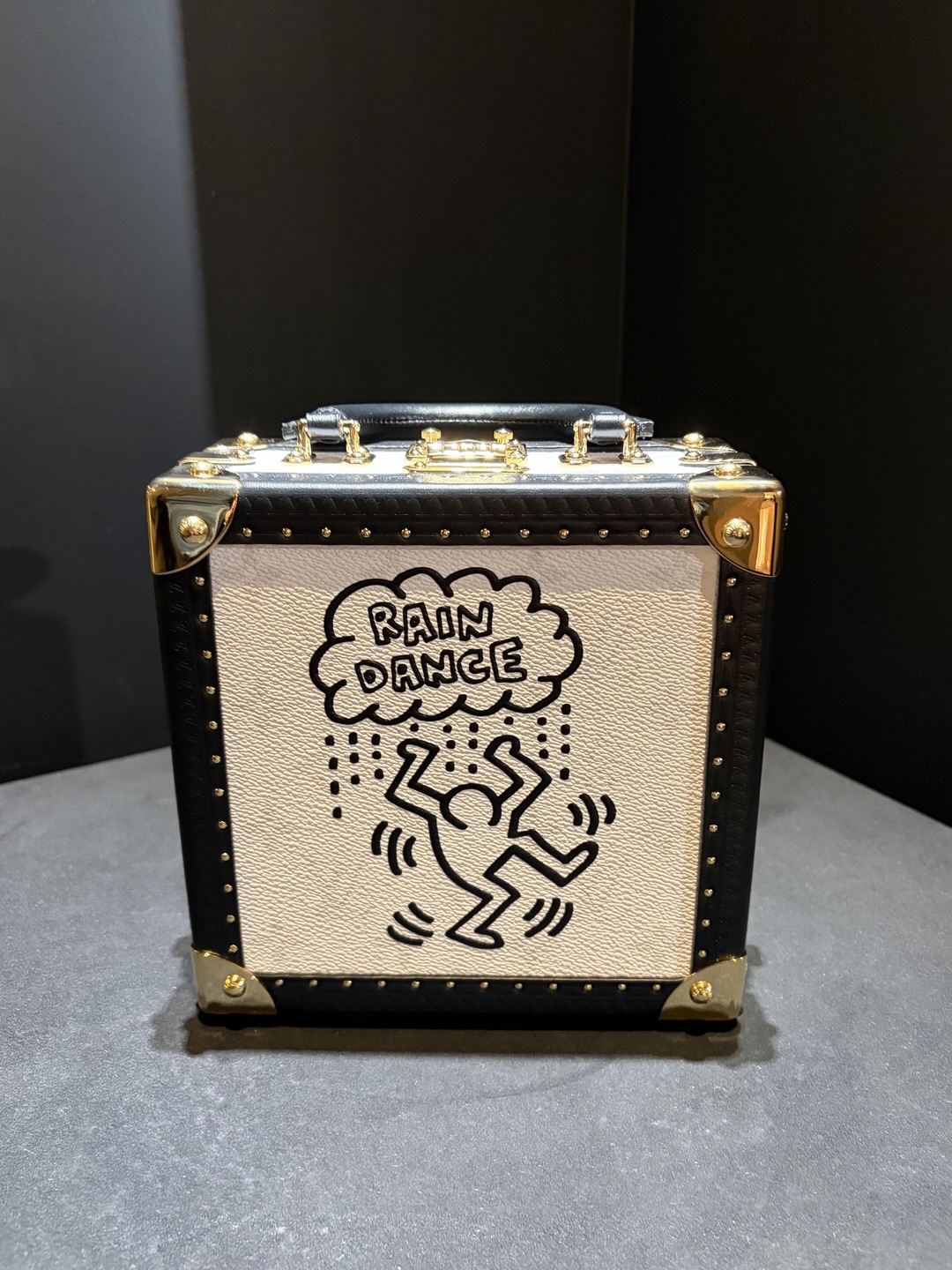 Small Louis Vuitton black and cream trunk bag marked Rain Dance with a dancing Keith Haring figure