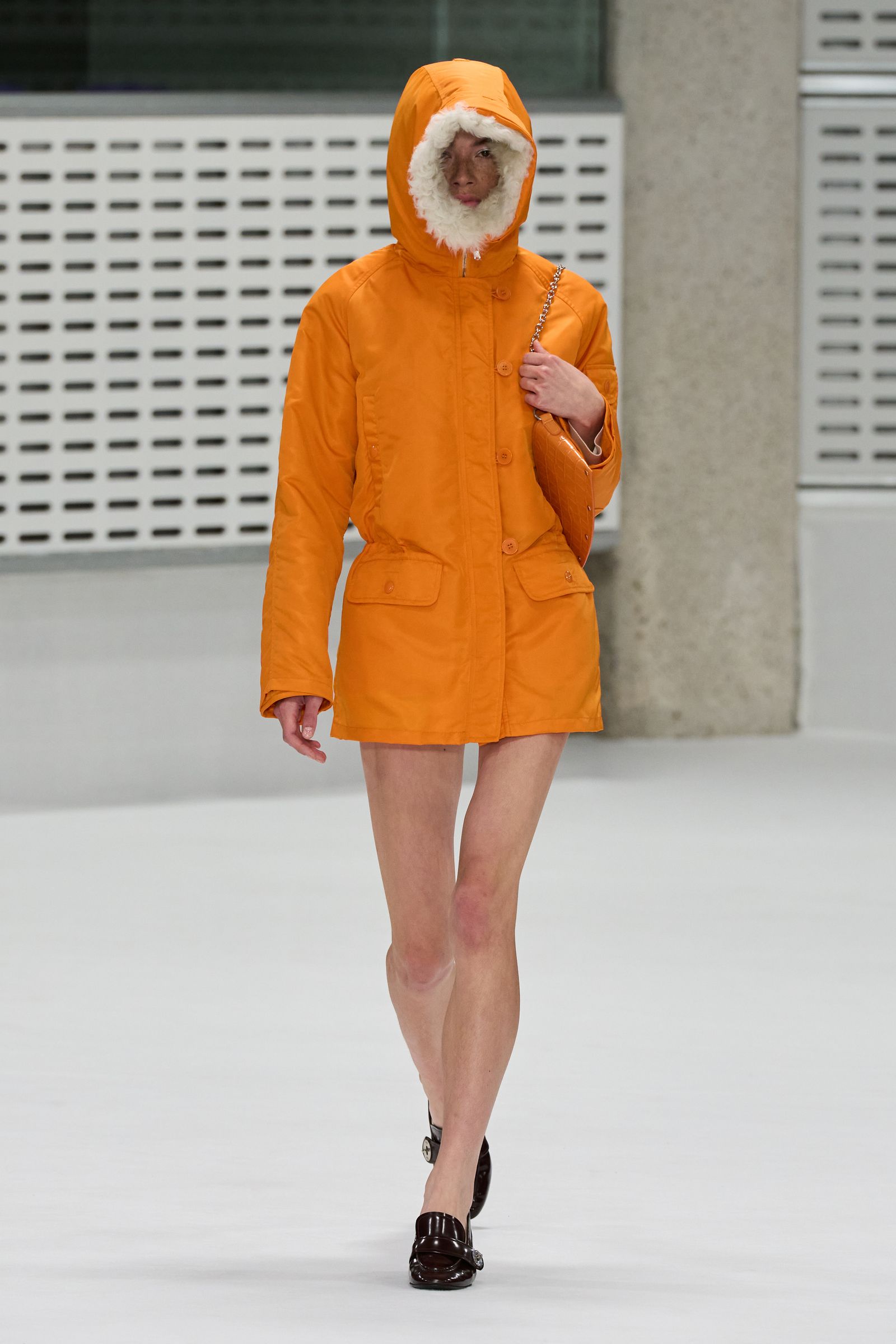 Orange parka and matching curved Mulberry bag on the Spring 2027 runway