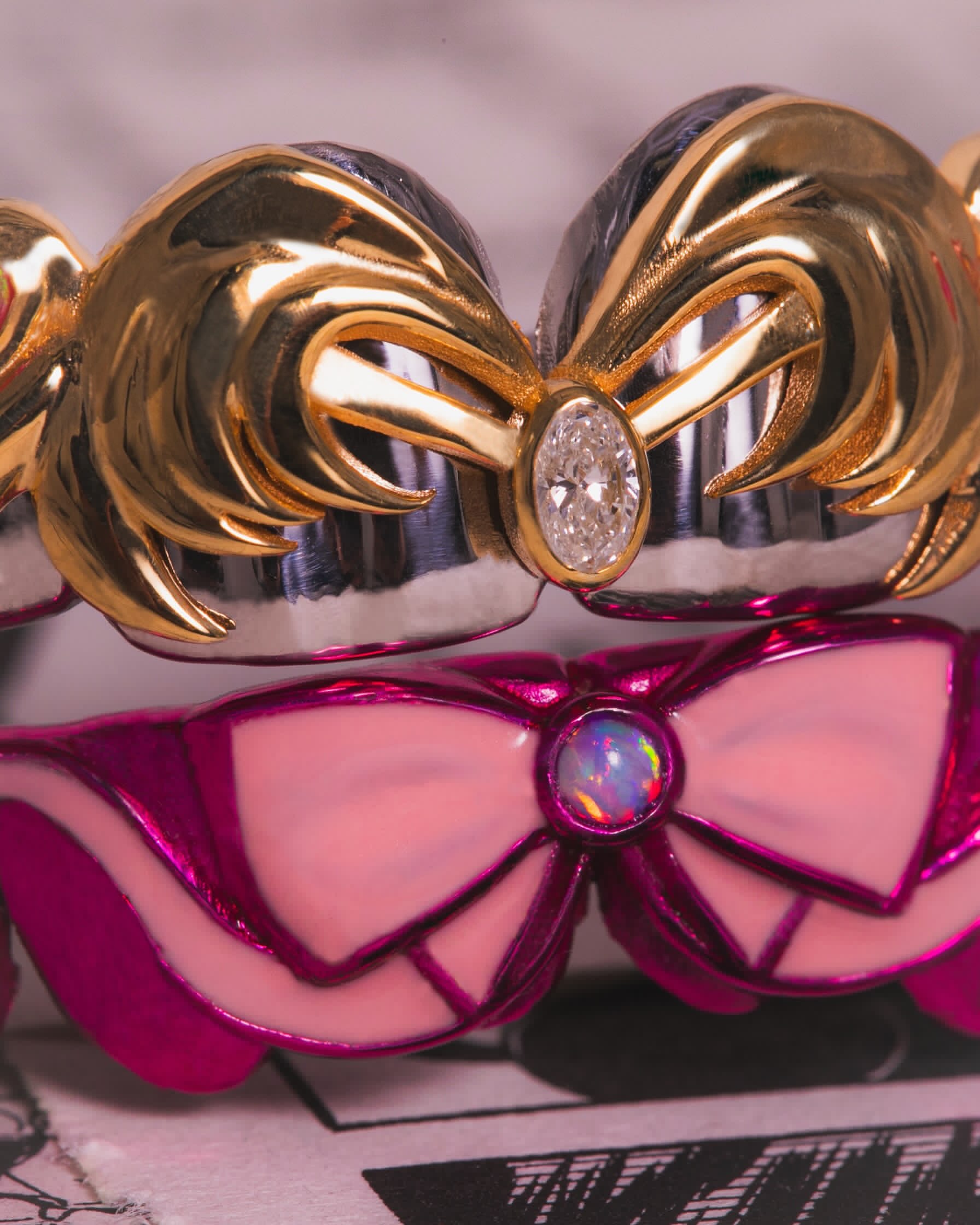 One-of-one Sailor Moon-inspired grill with golden crescent shapes, an oval diamond and a metallic pink bow set with an opal