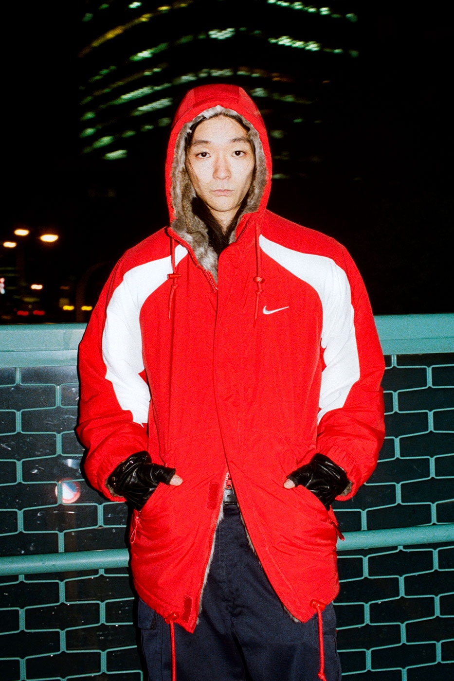Red and white Supreme x Nike parka worn in the campaign