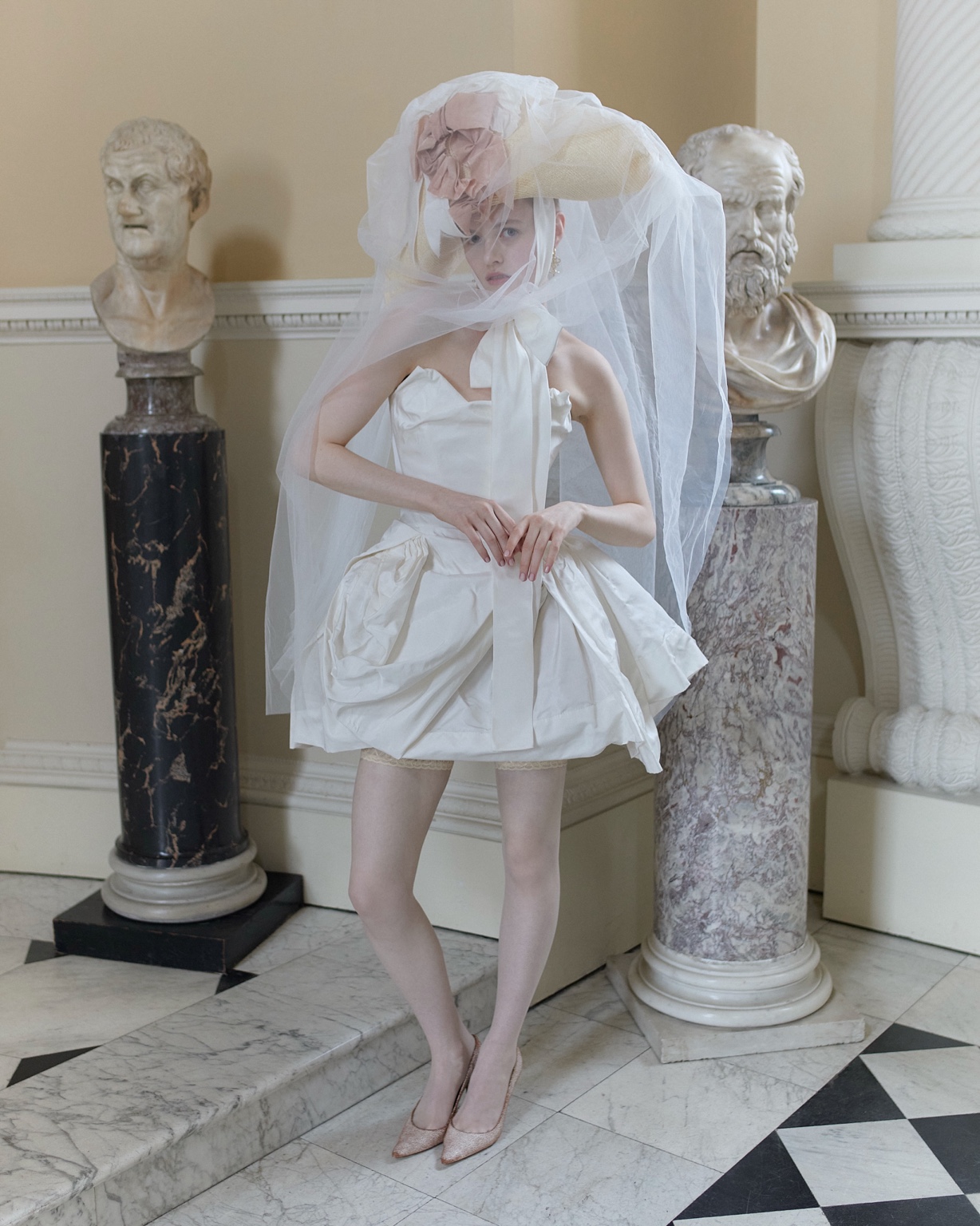 Vivienne Westwood 2027 sculptural bridal mini dress with an oversized veiled bonnet