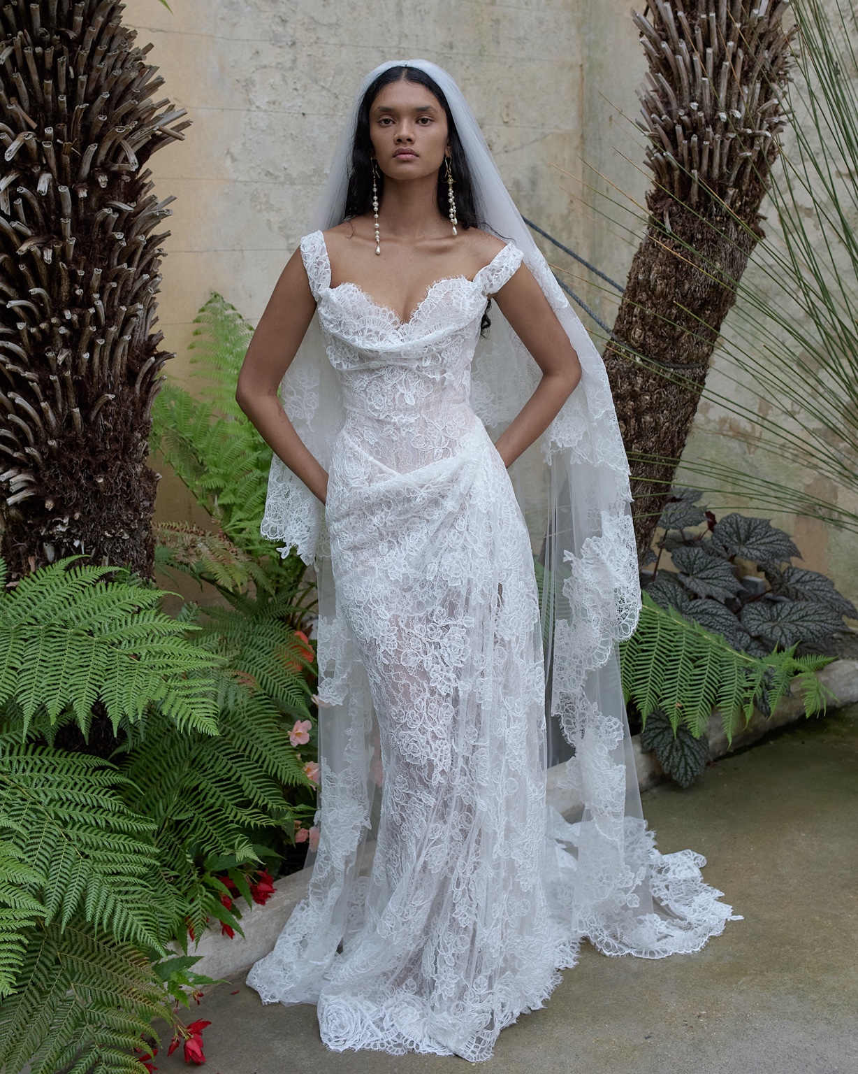 Vivienne Westwood white lace column gown with a long lace veil