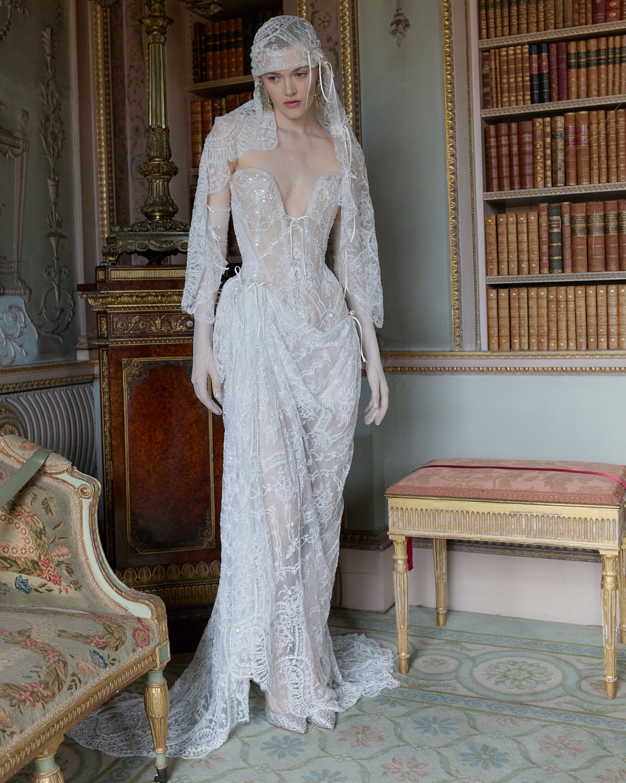 Vivienne Westwood 2027 lace corset bridal gown with a lace head covering